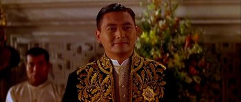 Movie still from “Anna and the King” (1999), directed by Andy Tennant – A person wearing a suit and tie; Close Up shot, Low angle