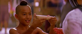 Movie still from “Anna and the King” (1999), directed by Andy Tennant – A young girl is holding a bamboo stick; Close Up shot, Low angle