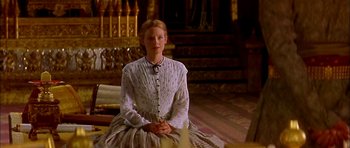 Movie still from “Anna and the King” (1999), directed by Andy Tennant – A woman sitting on the ground in a room; Medium shot, Low angle