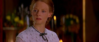 Movie still from “Anna and the King” (1999), directed by Andy Tennant – A person wearing a dress with lights in the background; Close Up shot, Over the shoulder angle