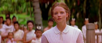 Movie still from “Anna and the King” (1999), directed by Andy Tennant – A woman in a white dress standing in front of a group of people; Close Up shot, Low angle