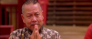 Movie still from “Anna and the King” (1999), directed by Andy Tennant – An older man is praying with his hands in front of his face; Close Up shot, Low angle