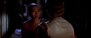 Movie still from “Anna and the King” (1999), directed by Andy Tennant – A woman is looking at another woman in the dark; Close Up shot, Over the shoulder angle