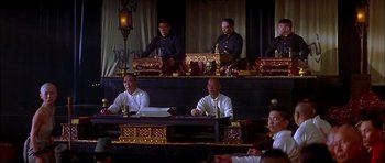 Movie still from “Anna and the King” (1999), directed by Andy Tennant – A group of people sitting at a table; Wide shot, High angle