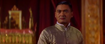 Movie still from “Anna and the King” (1999), directed by Andy Tennant – A person wearing a suit; Close Up shot, Low angle