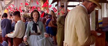 Movie still from “Anna and the King” (1999), directed by Andy Tennant – A woman dressed in period costume in front of a crowd of people; Medium shot, Low angle
