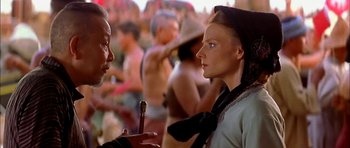 Movie still from “Anna and the King” (1999), directed by Andy Tennant – A man and a woman talking to each other in front of a group of people; Close Up shot, Over the shoulder angle