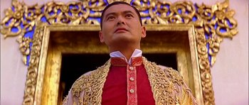 Movie still from “Anna and the King” (1999), directed by Andy Tennant – A person wearing a suit and tie; Close Up shot, Low angle