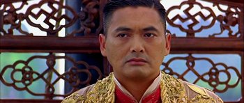 Movie still from “Anna and the King” (1999), directed by Andy Tennant – A person wearing a suit and tie; Close Up shot, Low angle