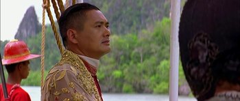 Movie still from “Anna and the King” (1999), directed by Andy Tennant – A person wearing a suit and tie; Close Up shot, Over the shoulder angle