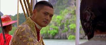 Movie still from “Anna and the King” (1999), directed by Andy Tennant – A person wearing a suit and tie; Close Up shot, Over the shoulder angle