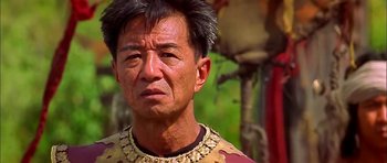 Movie still from “Anna and the King” (1999), directed by Andy Tennant – An older man wearing a gold necklace and a yellow shirt; Close Up shot, Over the shoulder angle