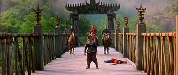 Movie still from “Anna and the King” (1999), directed by Andy Tennant – A group of people riding horses across a bridge; Wide shot, High angle