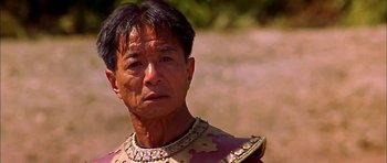 Movie still from “Anna and the King” (1999), directed by Andy Tennant – An older man wearing a necklace and a shirt; Close Up shot, Low angle