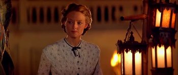 Movie still from “Anna and the King” (1999), directed by Andy Tennant – A woman in a white shirt is standing in front of a fire; Close Up shot, Over the shoulder angle