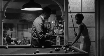 Movie still from “Anna Lucasta” (1958), directed by Arnold Laven – A man and a woman playing a game of billiards; Medium shot, High angle