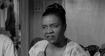 Movie still from “Anna Lucasta” (1958), directed by Arnold Laven – An old photo of an african american woman; Close Up shot, Low angle