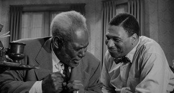 Movie still from “Anna Lucasta” (1958), directed by Arnold Laven – A black - and - white photo of two men talking; Medium shot, Low angle