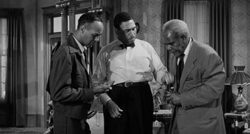 Movie still from “Anna Lucasta” (1958), directed by Arnold Laven – A group of men standing next to each other in a room; Medium shot, Low angle