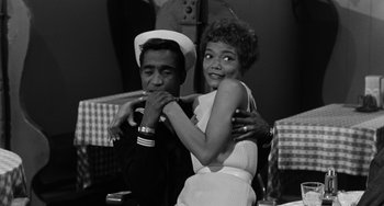 Movie still from “Anna Lucasta” (1958), directed by Arnold Laven – A man and a woman are hugging while holding each other; Medium shot, Low angle