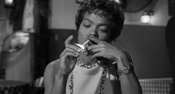 Movie still from “Anna Lucasta” (1958), directed by Arnold Laven – A black and white photo of a woman holding a pair of scissors; Close Up shot, Low angle