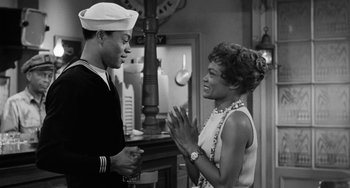 Movie still from “Anna Lucasta” (1958), directed by Arnold Laven – A man and a woman talking to each other; Medium shot, Over the shoulder angle