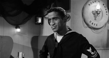 Movie still from “Anna Lucasta” (1958), directed by Arnold Laven – A black and white photo of a man in a sailor's uniform; Medium shot, Low angle