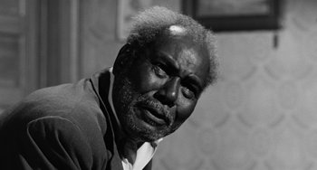 Movie still from “Anna Lucasta” (1958), directed by Arnold Laven – An older man with a beard and a white shirt; Close Up shot, Low angle