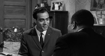 Movie still from “Anna Lucasta” (1958), directed by Arnold Laven – A man in a suit talking to another man in a suit and tie; Medium shot, Over the shoulder angle
