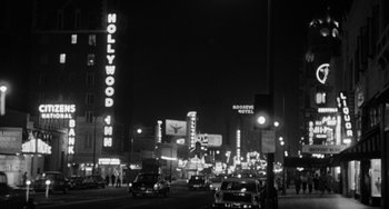 Movie still from “Anna Lucasta” (1958), directed by Arnold Laven – A black - and - white photo of a city street at night; Extreme Wide shot, Low angle