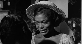 Movie still from “Anna Lucasta” (1958), directed by Arnold Laven – An old black and white photo of a woman wearing a straw hat; Close Up shot, Over the shoulder angle