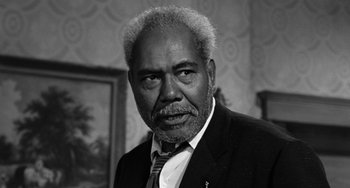 Movie still from “Anna Lucasta” (1958), directed by Arnold Laven – An older man in a suit and a tie; Close Up shot, Low angle