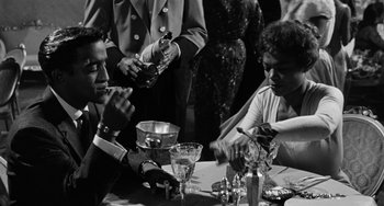 Movie still from “Anna Lucasta” (1958), directed by Arnold Laven – A black and white photo of people sitting at a table; Medium shot, Low angle