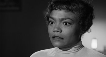 Movie still from “Anna Lucasta” (1958), directed by Arnold Laven – A black and white photo of a woman looking at the camera; Close Up shot, Low angle