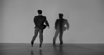 Movie still from “Anna Lucasta” (1958), directed by Arnold Laven – A black and white photo of a man in a suit; Wide shot, Low angle