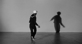 Movie still from “Anna Lucasta” (1958), directed by Arnold Laven – A black and white photo of a man in a sailor's uniform; Wide shot, Low angle