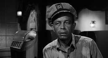 Movie still from “Anna Lucasta” (1958), directed by Arnold Laven – A man wearing a hat and looking at the camera; Close Up shot, Low angle