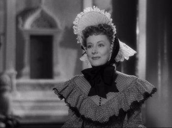 Movie still from “Anna and the King of Siam” (1946), directed by John Cromwell – An old photo of a woman wearing a hat; Close Up shot, Over the shoulder angle