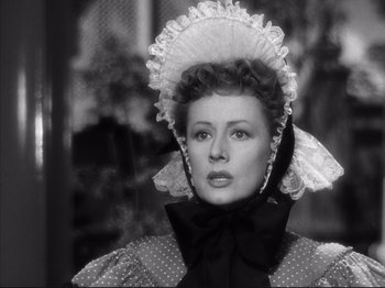 Movie still from “Anna and the King of Siam” (1946), directed by John Cromwell – A black and white photo of a woman wearing a hat; Close Up shot, Over the shoulder angle