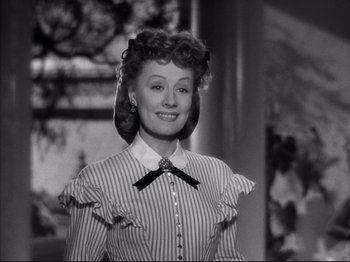 Movie still from “Anna and the King of Siam” (1946), directed by John Cromwell – An old photo of a woman smiling for the camera; Close Up shot, Low angle