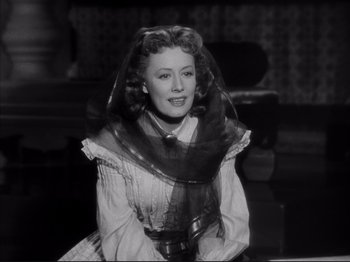 Movie still from “Anna and the King of Siam” (1946), directed by John Cromwell – An old black and white photo of a woman with a veil; Medium shot, Low angle