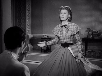 Movie still from “Anna and the King of Siam” (1946), directed by John Cromwell – An old photo of a woman in a dress; Medium shot, Over the shoulder angle