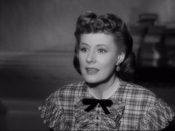 Movie still from “Anna and the King of Siam” (1946), directed by John Cromwell – An old photo of an older woman in a plaid dress; Close Up shot, High angle