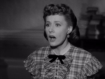 Movie still from “Anna and the King of Siam” (1946), directed by John Cromwell – An old photo of a woman in a plaid dress; Close Up shot, High angle