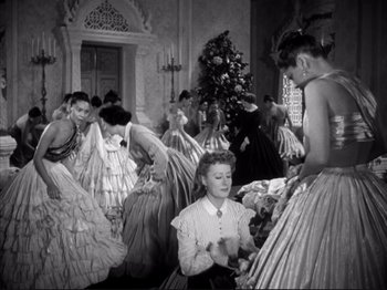 Movie still from “Anna and the King of Siam” (1946), directed by John Cromwell – A group of people in vintage dresses in a room; Wide shot, Low angle