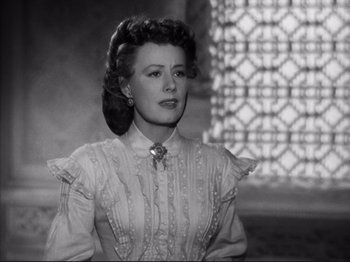 Movie still from “Anna and the King of Siam” (1946), directed by John Cromwell – An old black and white photo of a woman in a dress; Close Up shot, Low angle