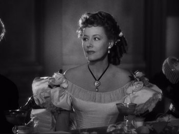 Movie still from “Anna and the King of Siam” (1946), directed by John Cromwell – An old photo of a woman sitting at a dinner table; Medium shot, Over the shoulder angle