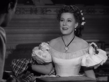 Movie still from “Anna and the King of Siam” (1946), directed by John Cromwell – An old photo of a woman in a dress; Medium shot, Low angle