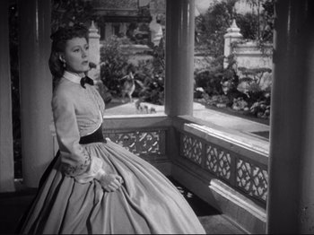 Movie still from “Anna and the King of Siam” (1946), directed by John Cromwell – A black and white photo of a woman in a dress; Medium shot, High angle
