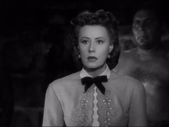 Movie still from “Anna and the King of Siam” (1946), directed by John Cromwell – An old photo of a woman with a bow tie; Close Up shot, Over the shoulder angle